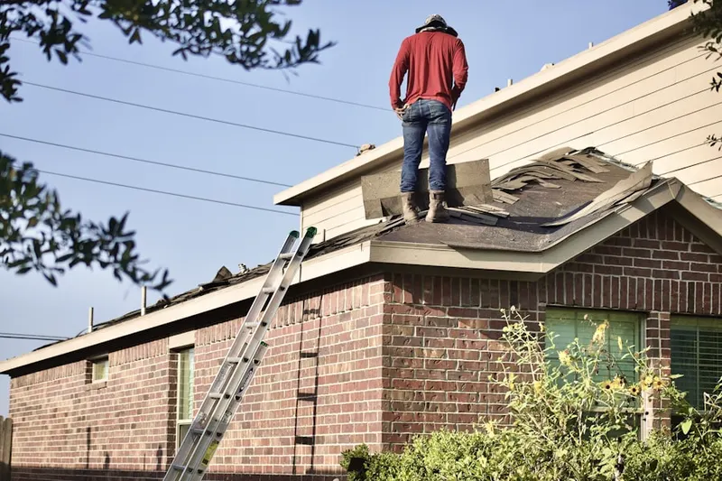 Professional roofer working on a residential roof in Northside Village